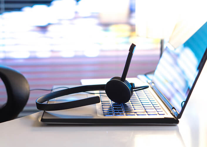 Customer service headset on laptop