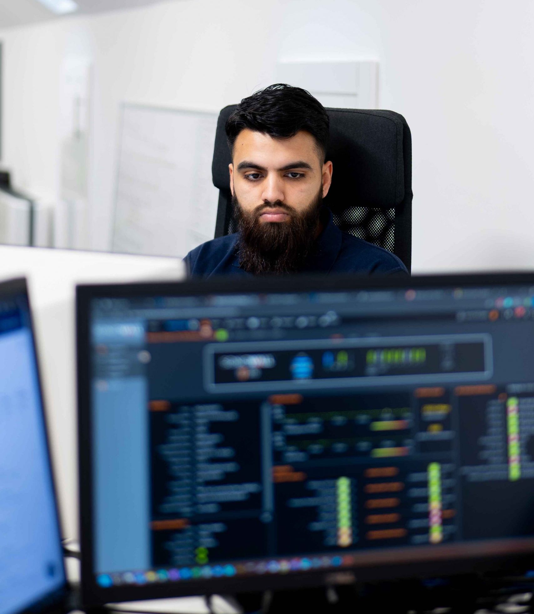 Cybersecurity analyst monitoring threat intelligence dashboards at Bluebell IT Solutions